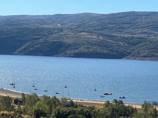 Expansive waterfront with a natural shoreline and distant mountainous terrain
