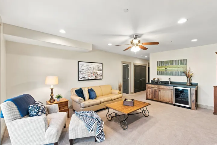 Spacious living area featuring recessed lighting, a ceiling fan, and carpeted flooring