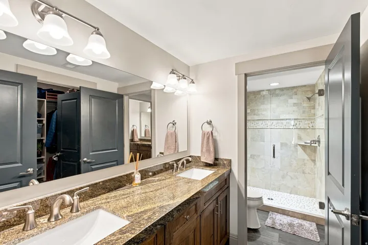 Dual vanity with stone countertop, undermount sinks, and brushed nickel fixtures