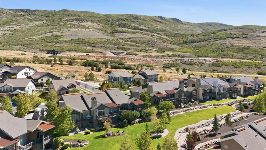 Neighborhood featuring varied architectural styles, mature landscaping, and mountain backdrop