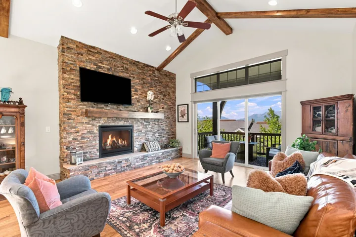 Vaulted ceiling with exposed wood beams and recessed lighting