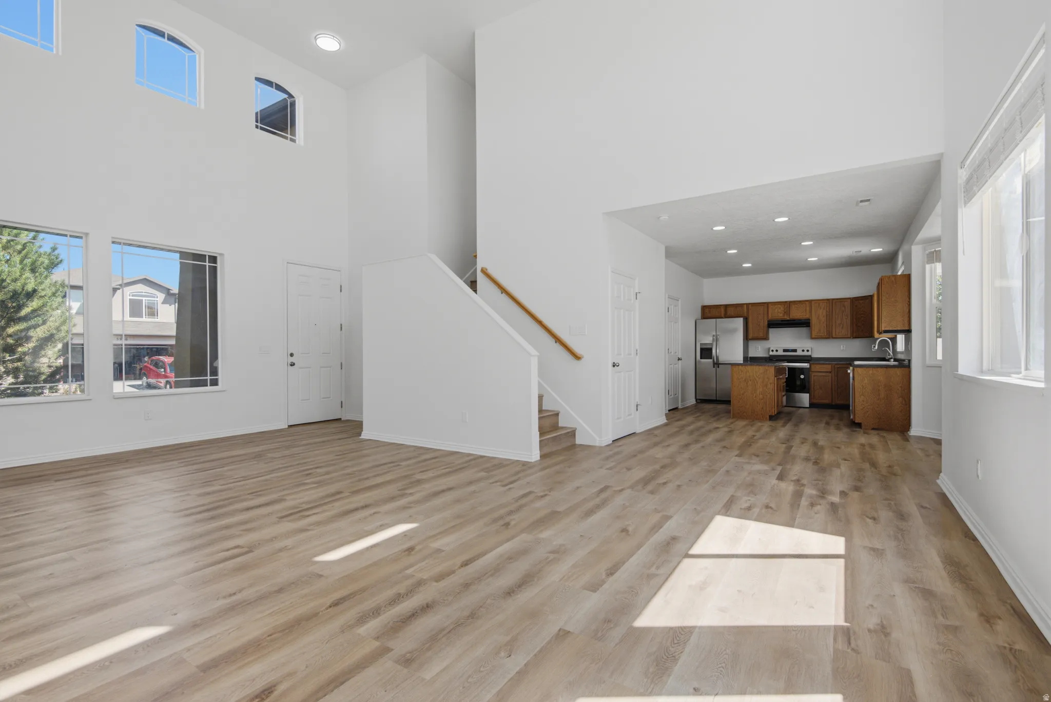 Vaulted ceilings, wood-finish flooring, and multiple windows