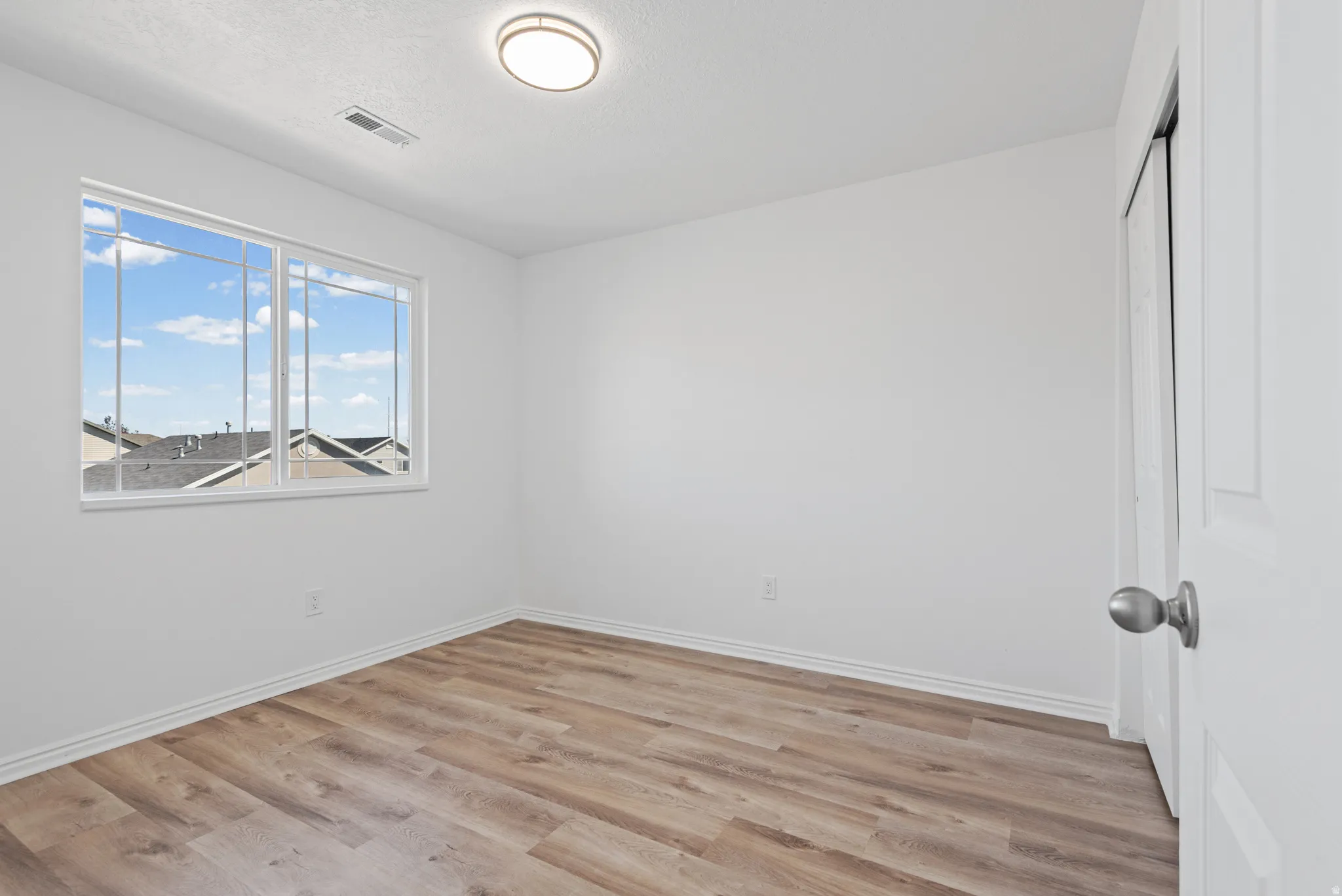 Wood-finish flooring with white baseboards