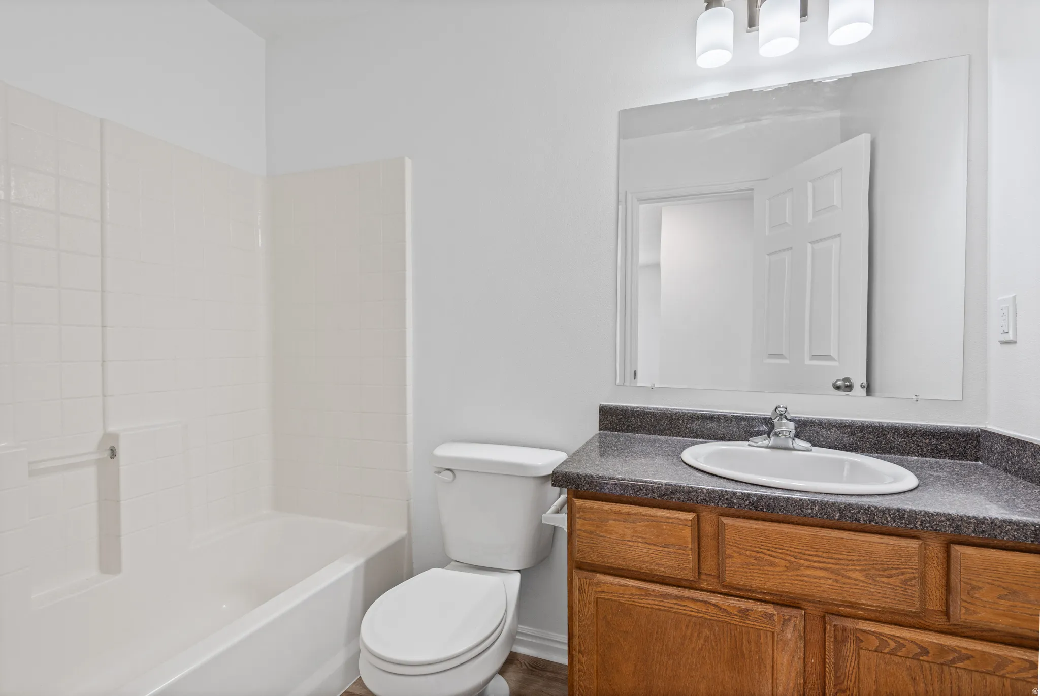White subway tile shower surround with integrated bathtub