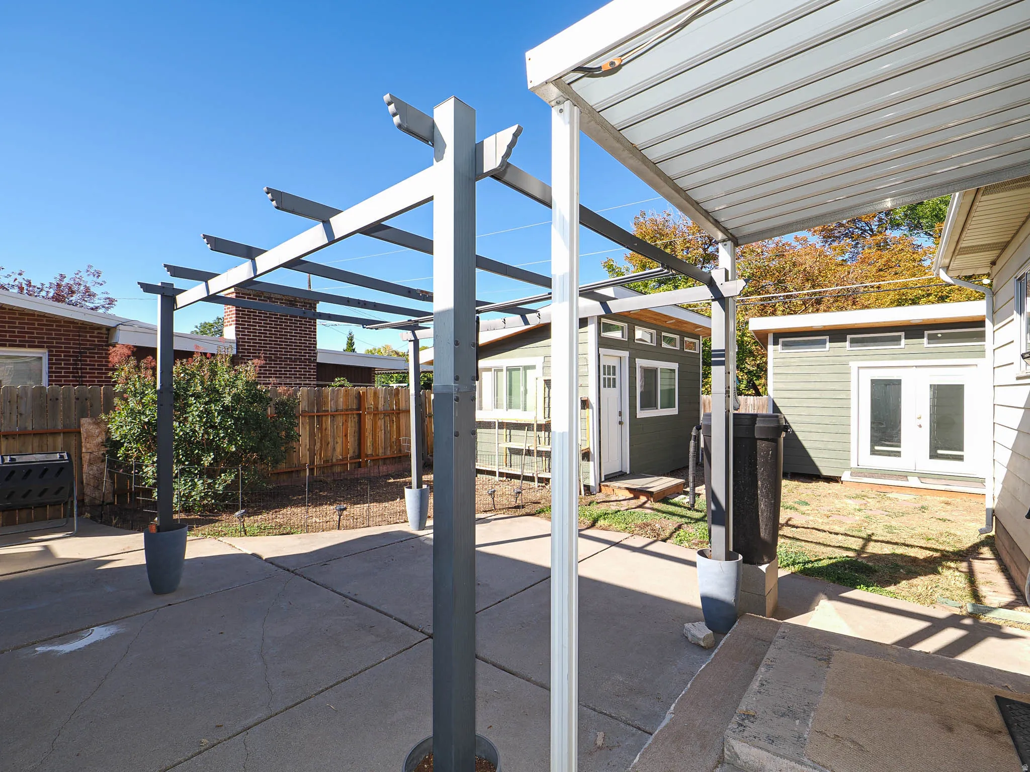 Patio with view of detached structures.
