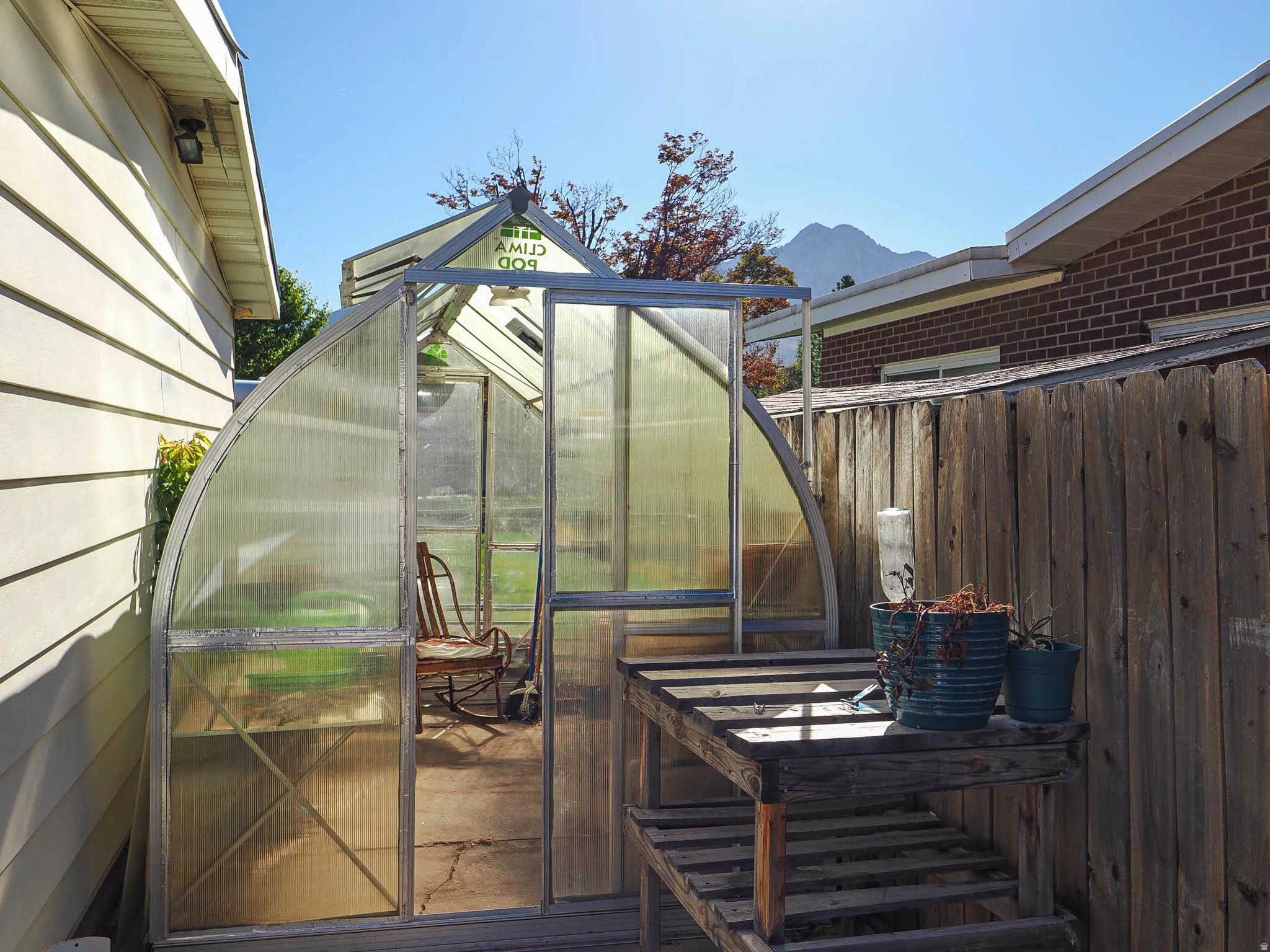 Green house on south side of garage. Space could be used for rv parking instead.