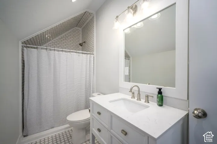 Vanity with white shaker-style cabinetry, undermount sink, and brushed nickel fixtures