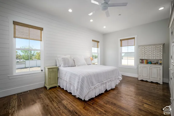 Hardwood flooring, shiplap wall accent, recessed lighting, ceiling fan, multiple windows with natural light
