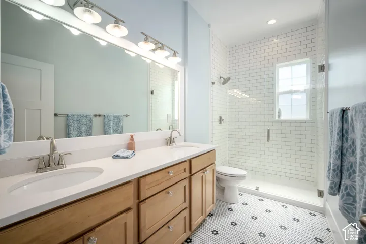 Dual vanity with light wood-finish cabinetry and white countertops