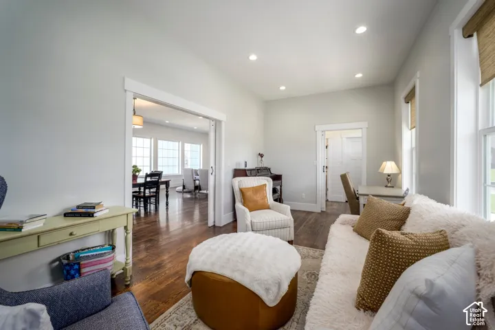 Hardwood-style flooring throughout, recessed lighting, and white trim