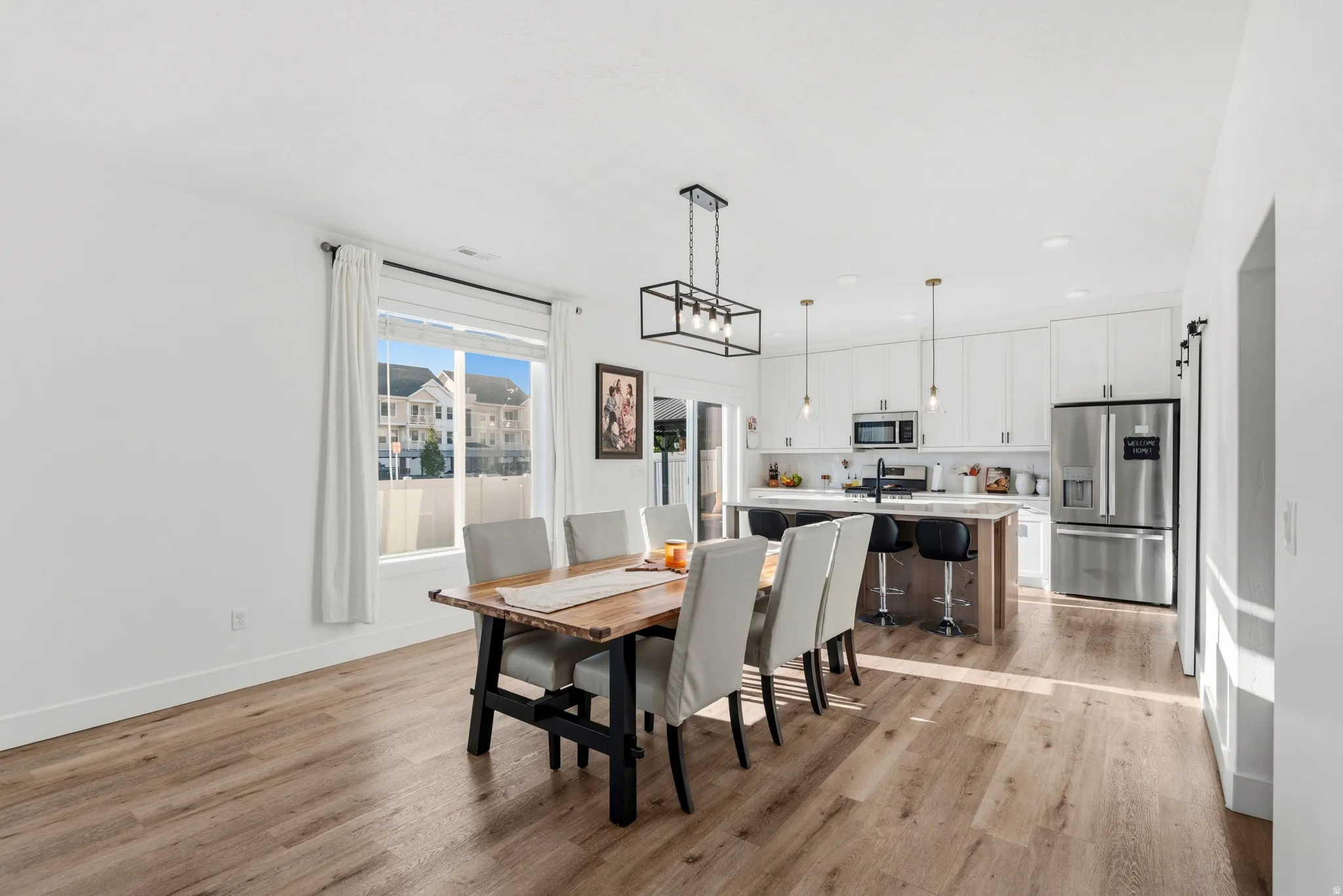 Open-concept dining space with wood-finish flooring