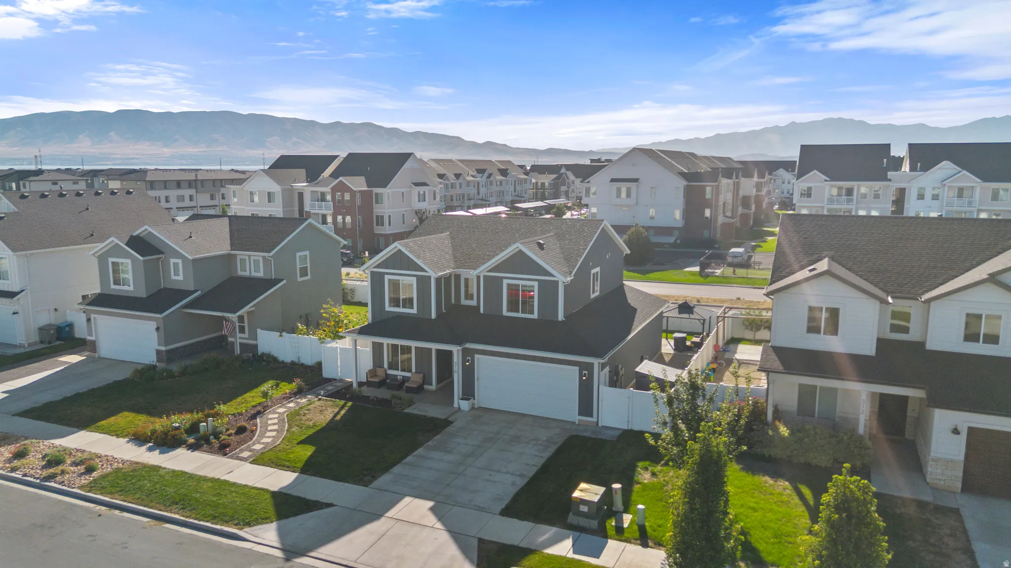 Two-story exterior with a two-car garage, front porch, and established landscaping