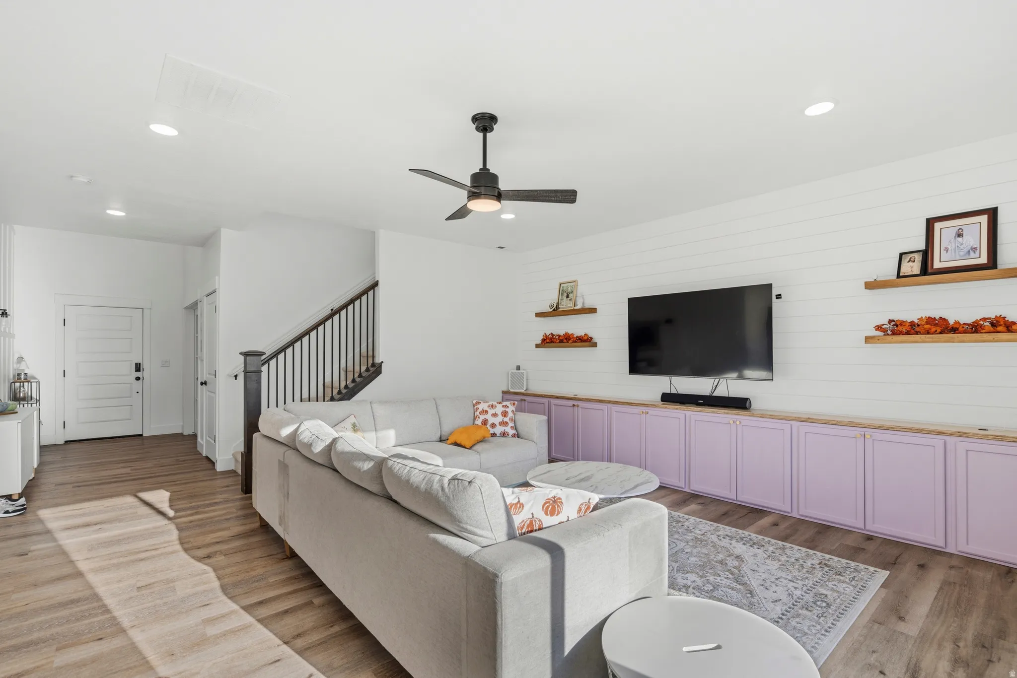 Wood-finish flooring throughout, recessed lighting, and a ceiling fan