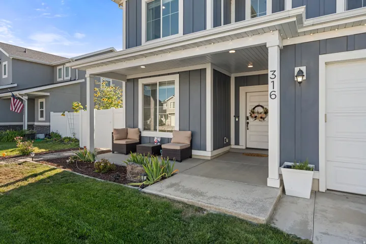 Covered front porch with concrete flooring and board and batten siding