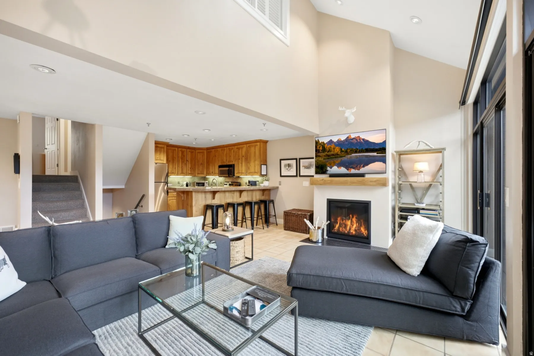 Open Main Level Living Concept with Vaulted Ceiling, Gas fireplace and wall of sliders to Patio.