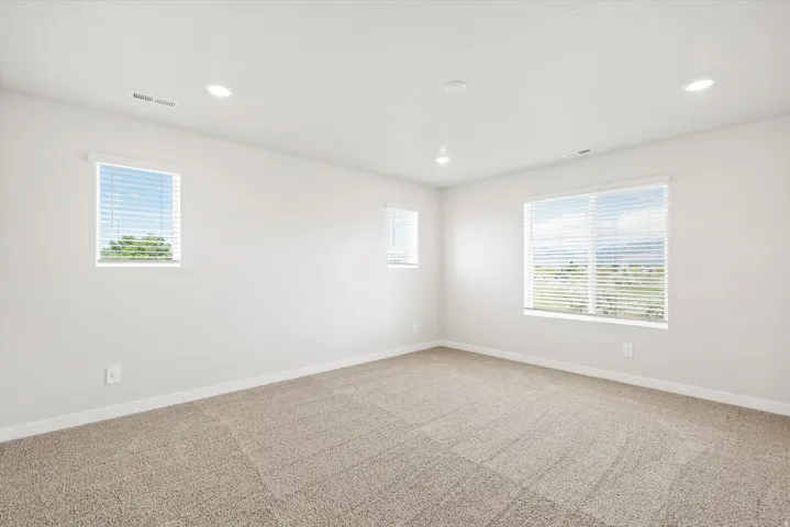 Neutral-toned carpeting paired with light-colored walls