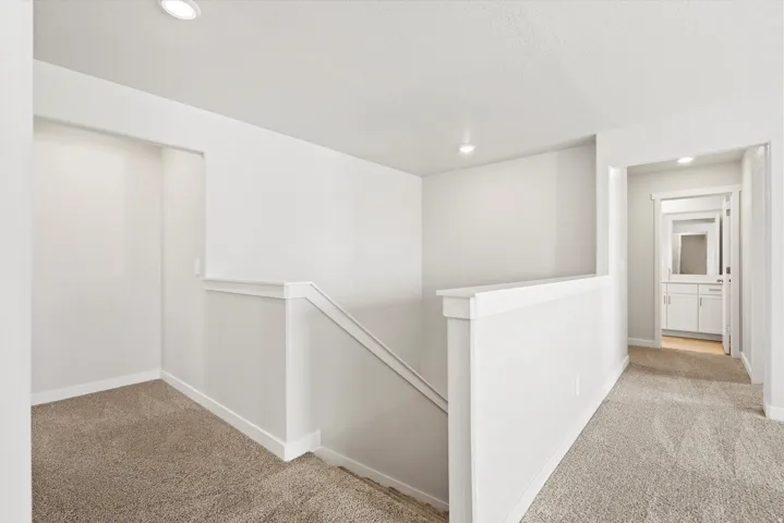 **DISCLAIMER** Some upgrades are not photographed. Carpeted hallway with recessed lighting and white painted walls