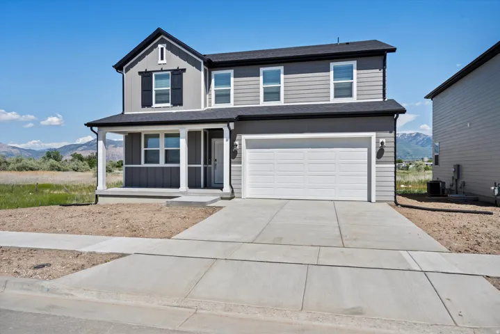 Two-story exterior with gray siding, white trim, and black shutters