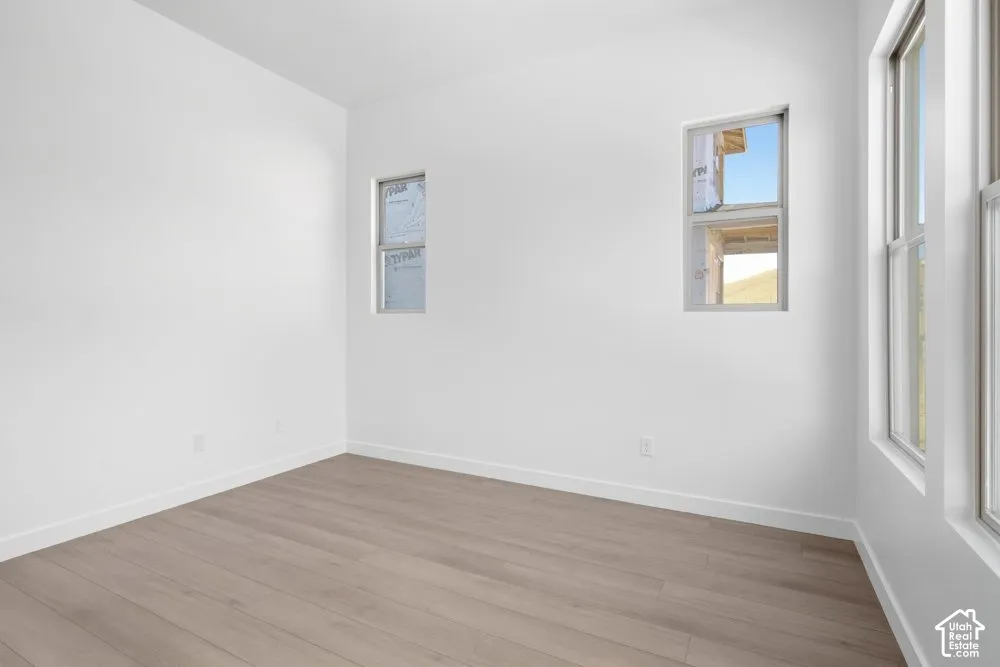 Neutral wall finish, wood-finish flooring, and multiple dual-pane windows