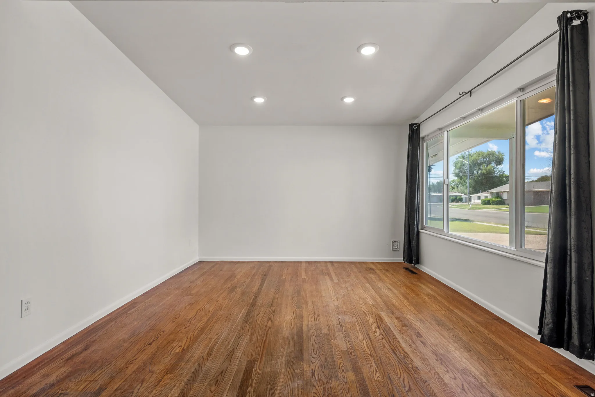 Living Room featuring large window, recessed lighting and hardwood floors