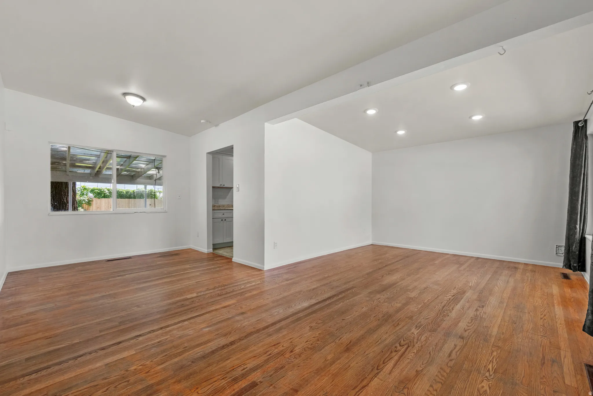 Living & Dining Room featuring large window, recessed lighting and hardwood floors