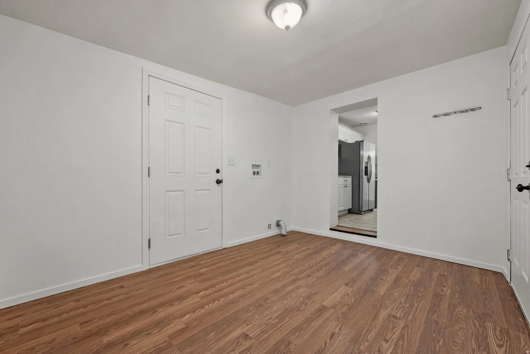 Laundry room with exterior doors and doorway into kitchen