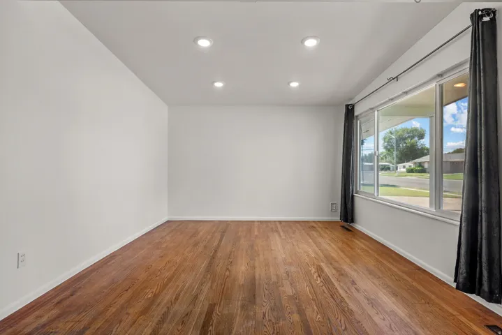 Living Room featuring large window, recessed lighting and hardwood floors
