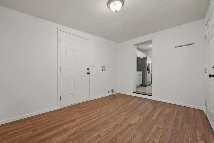 Laundry room with exterior doors and doorway into kitchen