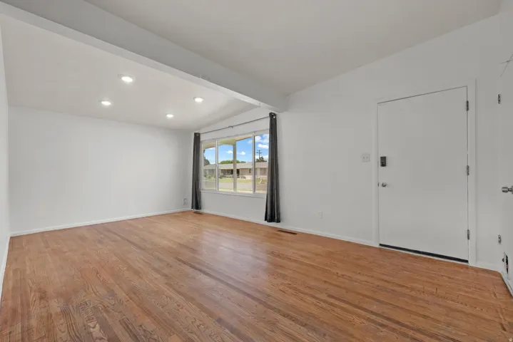 Living Room featuring large window, recessed lighting and hardwood floors