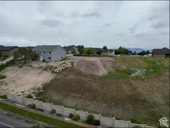 Expansive undeveloped lot with a partial retaining wall