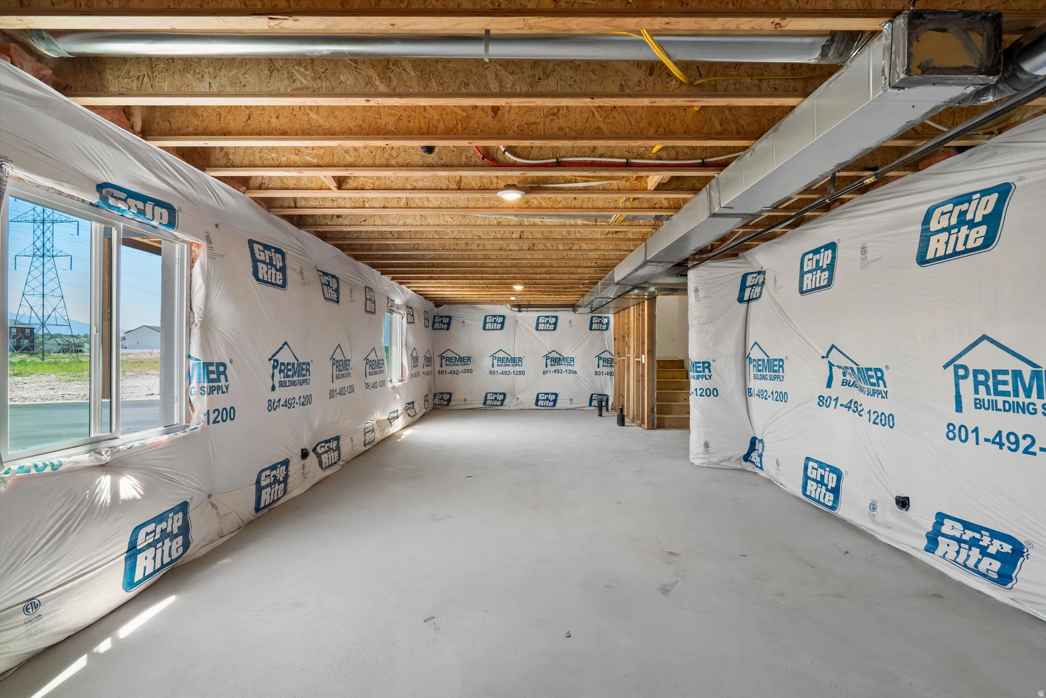 Daylight basement with multiple windows and concrete flooring