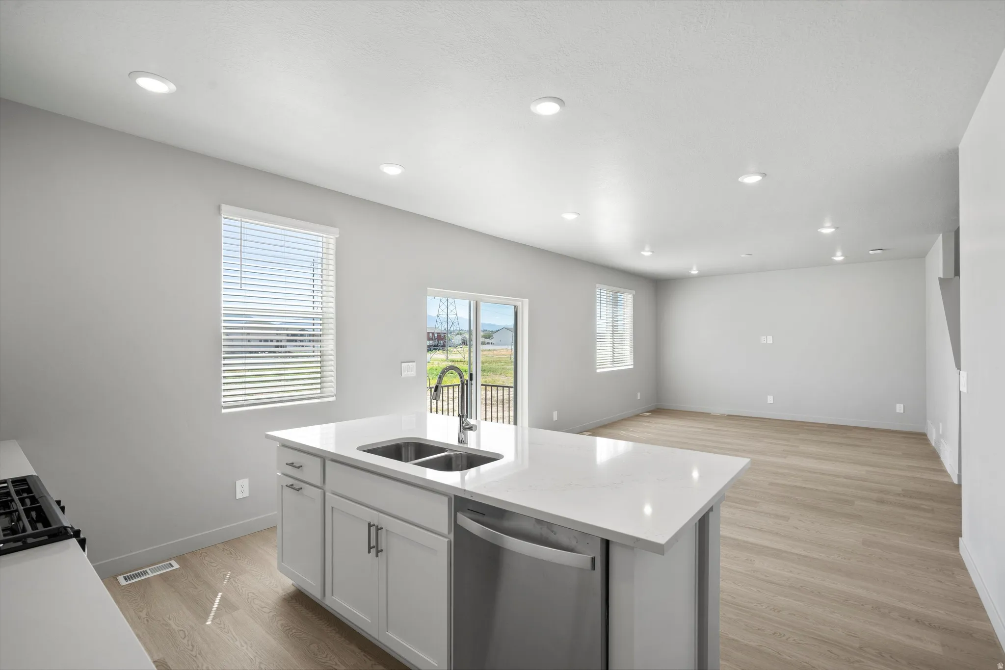 Kitchen island featuring a dual basin sink and integrated dishwasher
