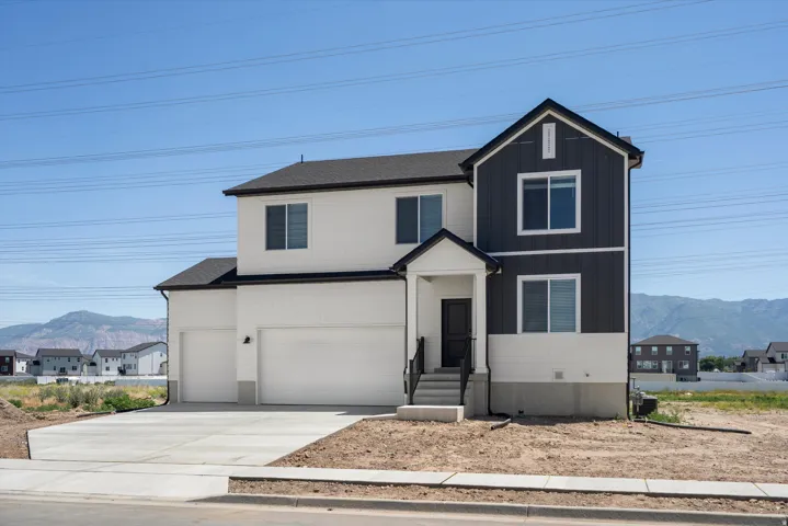 Two-story exterior with a covered entry, two-car garage, and dark-framed windows