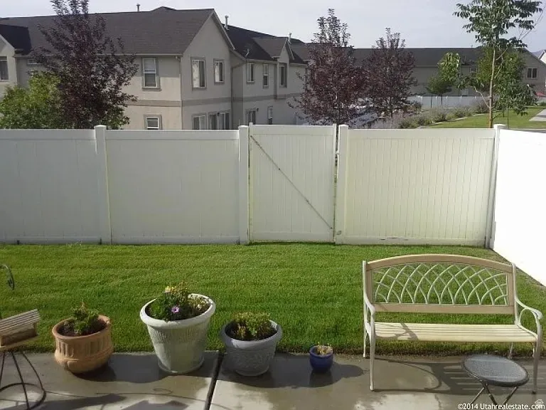 Manicured lawn with a privacy fence and gate