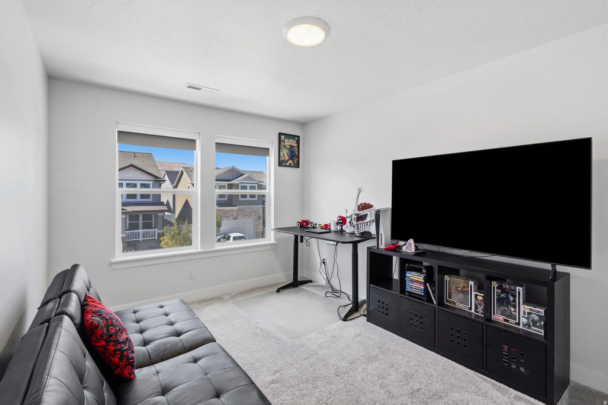 Recessed ceiling light, two large windows, light gray wall paint, and light-colored carpet