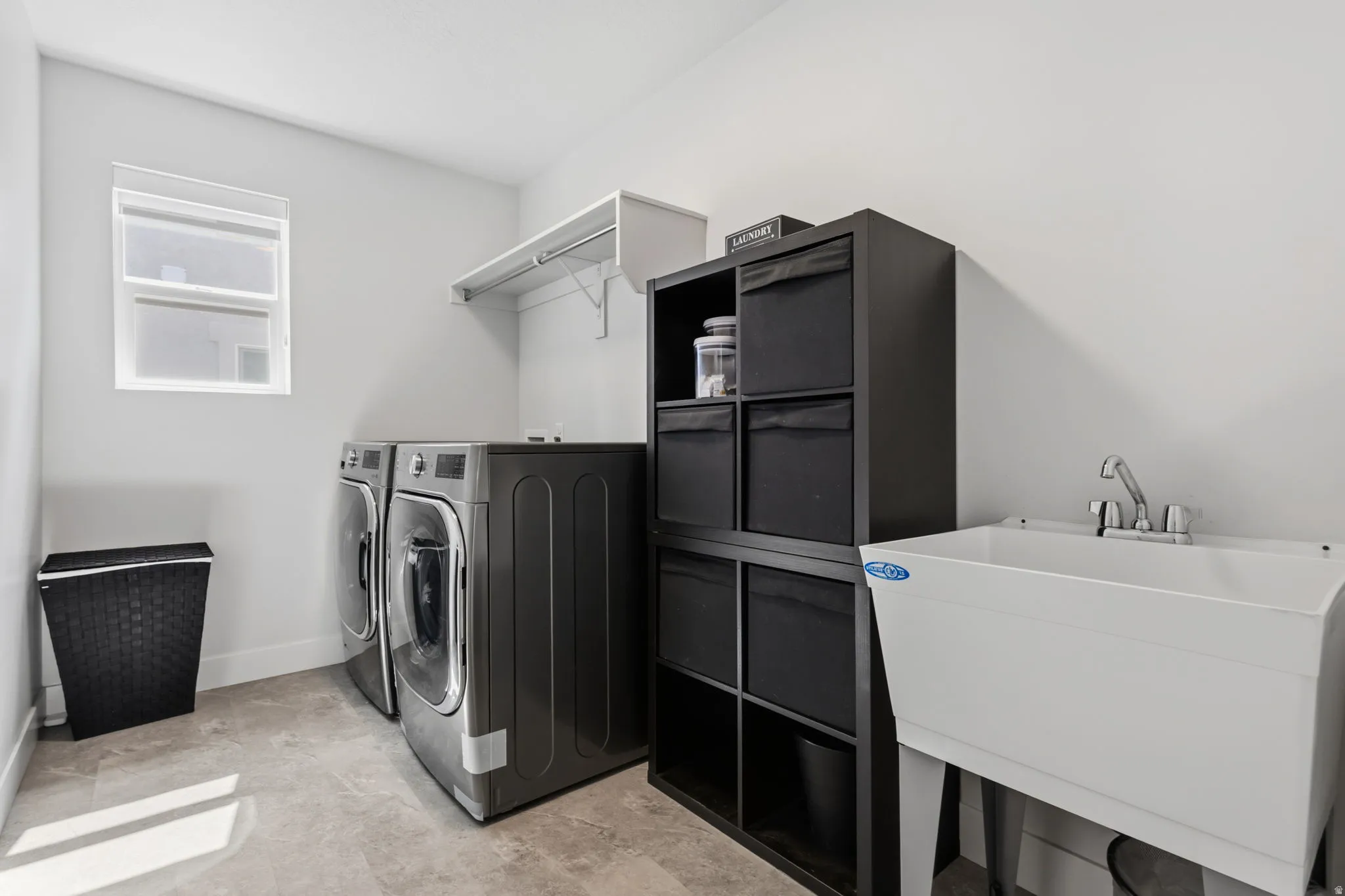 Tile flooring, utility sink, and wall-mounted shelving