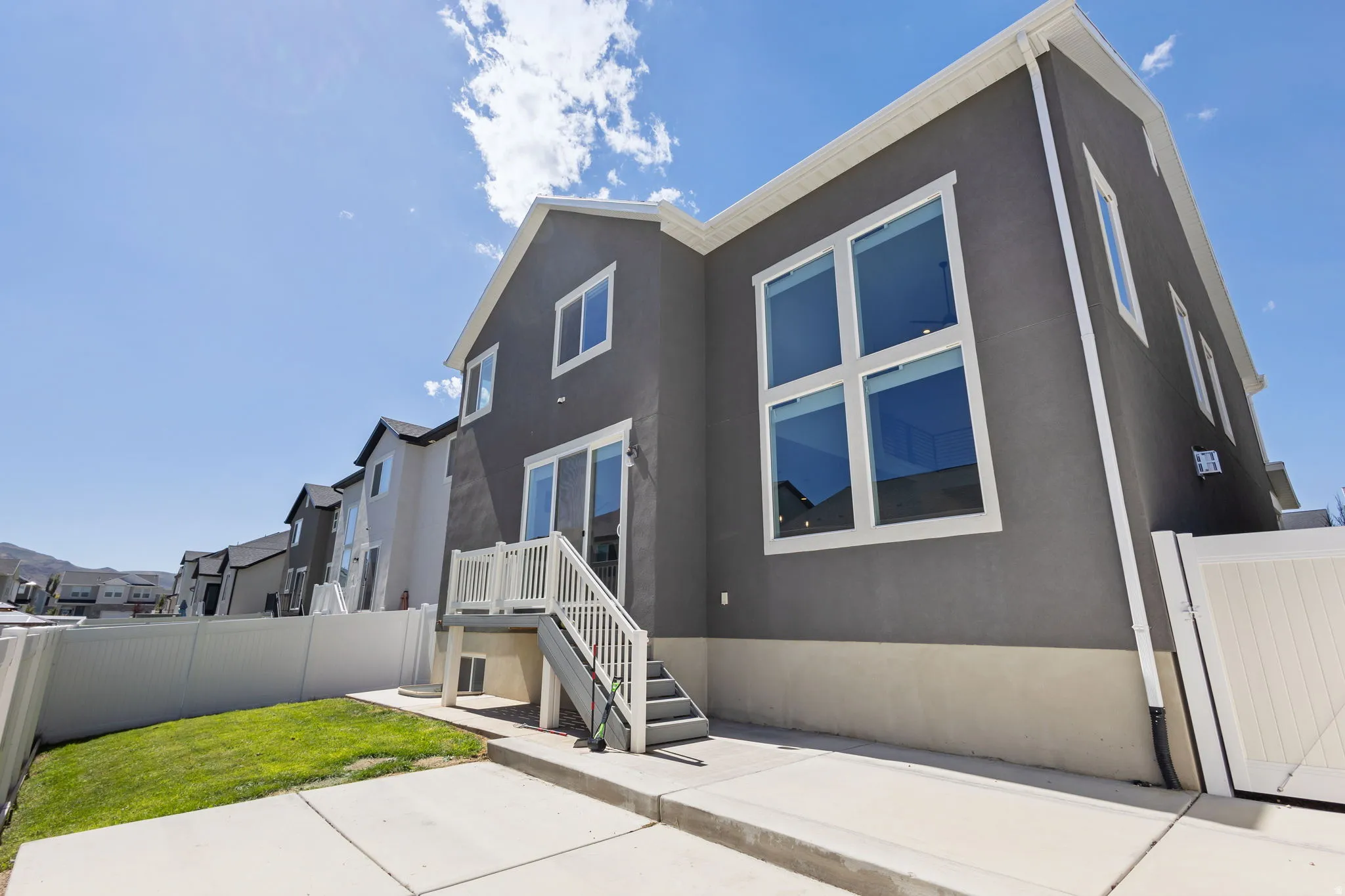 Contemporary gray stucco exterior with white trim