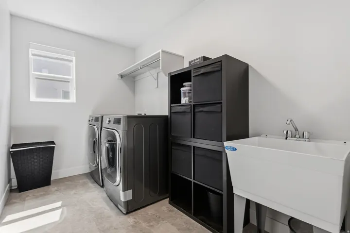 Tile flooring, utility sink, and wall-mounted shelving