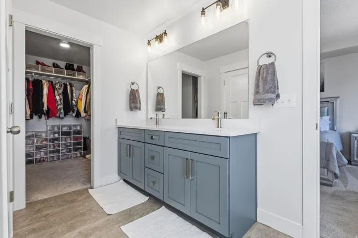 Double vanity with light gray cabinetry and white countertop