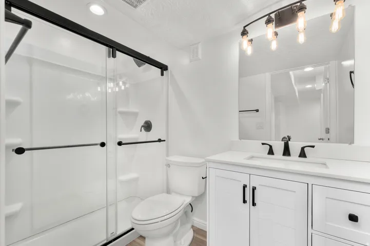 White shaker-style vanity with a light-toned countertop