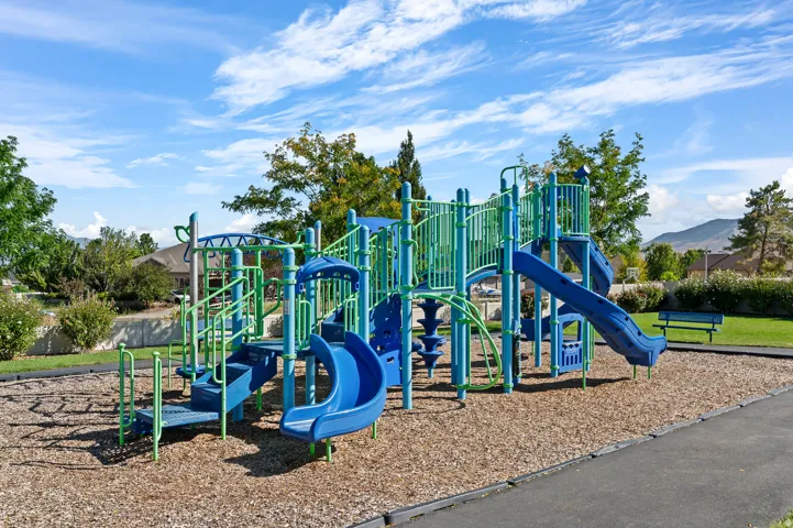 Community playground featuring multiple slides and climbing structures