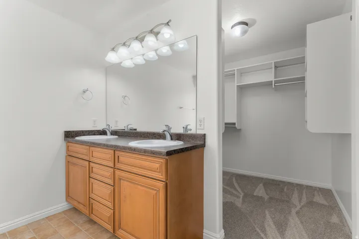 Dual vanity with a dark countertop and undermount sinks