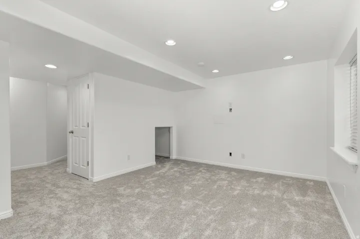 Recessed lighting, light gray carpet, and white painted walls