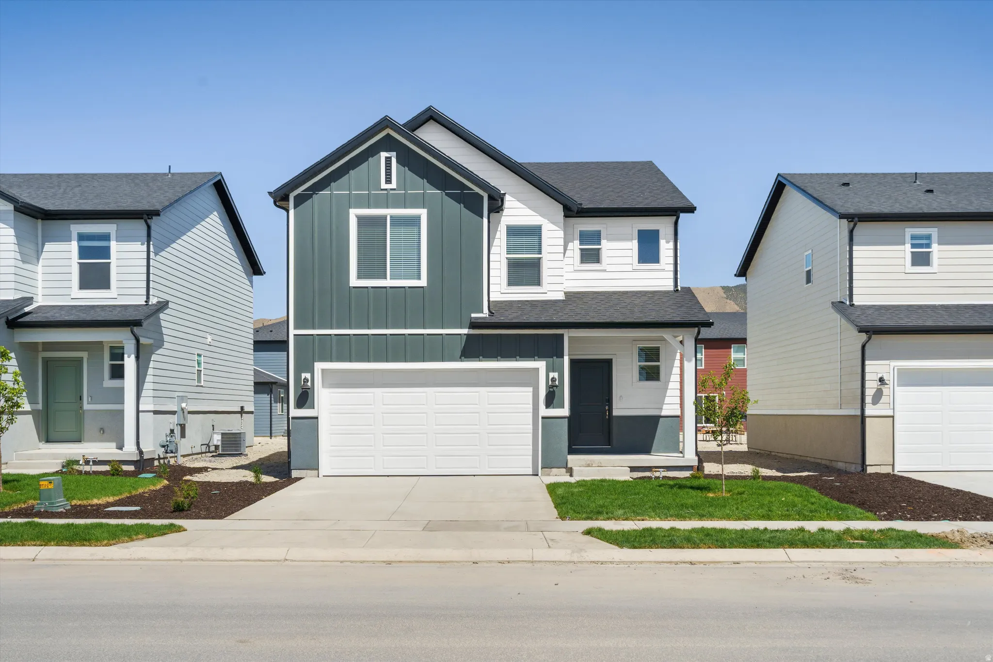 **DISCLAIMER** Elevation may vary.  Contemporary two-story residence featuring a two-tone exterior, attached two-car garage, and a black shingle roof