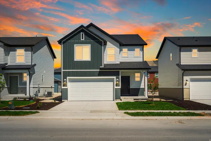 **DISCLAIMER** Elevation may vary.  Two-story exterior with board and batten siding, two-car garage, covered entry, and dark roof
