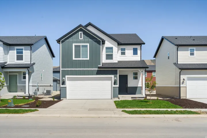 **DISCLAIMER** Elevation may vary.  Contemporary two-story residence featuring a two-tone exterior, attached two-car garage, and a black shingle roof