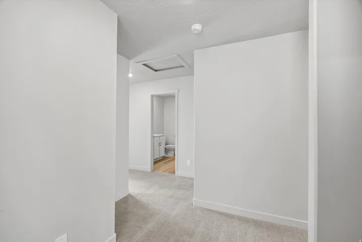 Neutral-toned walls with ceiling-mounted light fixtures