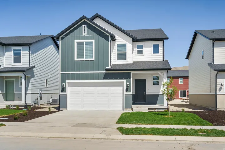 **DISCLAIMER** Elevation may vary.  Modern exterior featuring vertical and horizontal siding, a two-car garage, and a covered entry