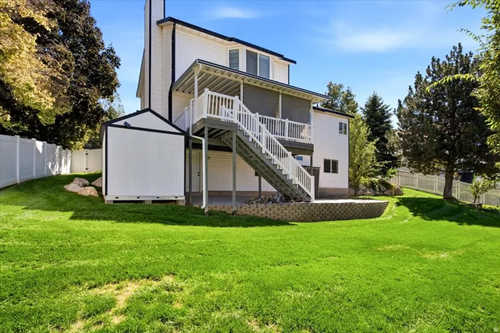 Expansive green lawn with a white vinyl fence