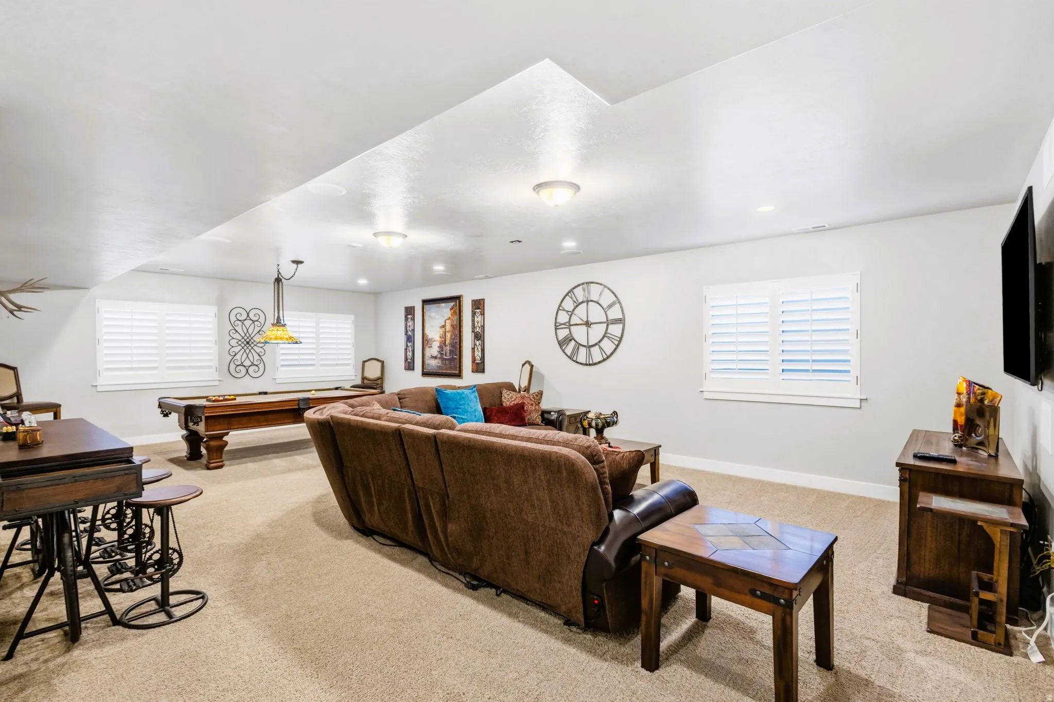 Recessed lighting, plantation shutters, and carpeted flooring